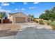 Charming single-story home with a well-maintained front yard and a two-car garage at 16158 W Coronado Rd, Goodyear, AZ 85395