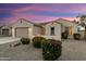 Beautiful exterior view of a home at twilight, highlighting colorful landscaping and desert accents at 16158 W Coronado Rd, Goodyear, AZ 85395