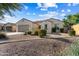 Attractive home exterior featuring desert landscaping, a tile roof, and a welcoming front entrance at 16158 W Coronado Rd, Goodyear, AZ 85395