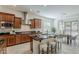 Well-equipped kitchen boasts dark wood cabinetry, stainless steel appliances, and breakfast bar with stool seating at 16158 W Coronado Rd, Goodyear, AZ 85395