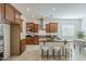 Inviting kitchen features dark wood cabinetry, stainless steel appliances and a breakfast bar with stool seating at 16158 W Coronado Rd, Goodyear, AZ 85395