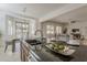 Modern kitchen island with granite counters, stainless steel sink, and open concept to dining and living areas at 16158 W Coronado Rd, Goodyear, AZ 85395