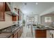Charming kitchen offers gas cooktop and stainless steel hood vent, connected to a dining area and breakfast bar at 16158 W Coronado Rd, Goodyear, AZ 85395