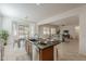 Open concept kitchen with breakfast bar, stainless steel appliances, and clear view into the dining and living areas at 16158 W Coronado Rd, Goodyear, AZ 85395