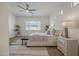 Bright main bedroom featuring neutral tones, ceiling fan, large window, and cozy rug at 16158 W Coronado Rd, Goodyear, AZ 85395