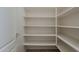 Walk-in pantry featuring white shelving units at 16158 W Coronado Rd, Goodyear, AZ 85395