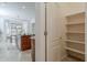 View of the kitchen and the walk-in pantry with shelving at 16158 W Coronado Rd, Goodyear, AZ 85395