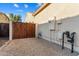 Gated side yard with neutral rock and outdoor utilities, offering secure and functional space at 16158 W Coronado Rd, Goodyear, AZ 85395
