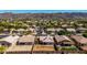 Aerial view of the home with mature landscaping and views of the nearby mountains at 1634 E Harwell Rd, Phoenix, AZ 85042