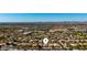 Wide aerial view of the property in its neighborhood and mountain views in the distance at 1634 E Harwell Rd, Phoenix, AZ 85042
