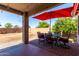 Covered patio with patio set and backyard view at 1634 E Harwell Rd, Phoenix, AZ 85042