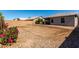 Large backyard with flower bush and rock area at 1634 E Harwell Rd, Phoenix, AZ 85042