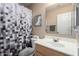 Small bathroom with shower curtain, toilet and sink at 1634 E Harwell Rd, Phoenix, AZ 85042