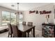 Breakfast nook with a dining table, large windows offering outdoor views, and custom beer and wine decor at 1634 E Harwell Rd, Phoenix, AZ 85042