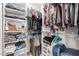 A well-organized walk-in closet offering ample storage solutions with shelves, rods, and storage containers at 1634 E Harwell Rd, Phoenix, AZ 85042
