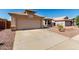 Lovely home showcasing a wide driveway, desert landscaping, and a convenient two-car garage at 1634 E Harwell Rd, Phoenix, AZ 85042