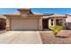 Charming home featuring a two-car garage, desert landscaping, and solar panels for energy efficiency at 1634 E Harwell Rd, Phoenix, AZ 85042