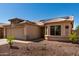 Inviting home featuring low-maintenance desert landscaping, solar panels, and a two-car garage at 1634 E Harwell Rd, Phoenix, AZ 85042