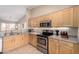Well-equipped kitchen with wooden cabinets, providing ample storage and a functional cooking space at 1634 E Harwell Rd, Phoenix, AZ 85042