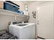 Modern laundry room with white washer and dryer and overhead storage at 1634 E Harwell Rd, Phoenix, AZ 85042