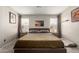 The main bedroom features neutral tones, large windows, and comfortable sleeping arrangements at 1634 E Harwell Rd, Phoenix, AZ 85042