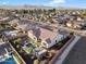 An aerial view shows a home with a pool, patio, and well-maintained landscaping at 18577 W Coolidge St, Goodyear, AZ 85395