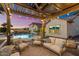 Enjoy outdoor living with a covered patio, comfortable seating, and a sparkling pool at 18577 W Coolidge St, Goodyear, AZ 85395