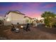 A charming backyard with string lights, an outdoor firepit, and a view of the pool at 18577 W Coolidge St, Goodyear, AZ 85395