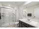 Bright bathroom featuring a walk-in shower with glass door, and updated vanity with granite countertop at 18577 W Coolidge St, Goodyear, AZ 85395