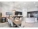 Elegant dining area featuring a modern chandelier and access to the kitchen at 18577 W Coolidge St, Goodyear, AZ 85395
