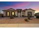 Charming single-story home with well-maintained landscaping and a welcoming entrance at 18577 W Coolidge St, Goodyear, AZ 85395