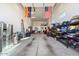 Spacious garage featuring ample storage, tools, and recreational equipment at 18577 W Coolidge St, Goodyear, AZ 85395