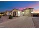 Spacious three-car garage with a brick paved driveway and desert landscaping at 18577 W Coolidge St, Goodyear, AZ 85395