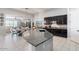 Stylish kitchen island with stone countertop and modern appliances with an open floor plan at 18577 W Coolidge St, Goodyear, AZ 85395