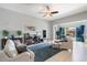 Bright living room with tile floors, neutral tones, and sliding glass doors to the backyard at 18577 W Coolidge St, Goodyear, AZ 85395