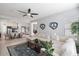 Bright and airy living room featuring a large sectional sofa and open floor plan to the dining area at 18577 W Coolidge St, Goodyear, AZ 85395