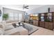 Comfortable living room with large sectional, ceiling fan, and custom display cabinet at 18577 W Coolidge St, Goodyear, AZ 85395