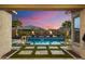 Backyard oasis with refreshing pool, manicured landscaping, and palm trees at 18577 W Coolidge St, Goodyear, AZ 85395
