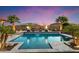 Inviting swimming pool with fire features, lounge chairs, and lush landscaping; perfect for relaxation at 18577 W Coolidge St, Goodyear, AZ 85395