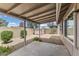 Covered back patio with desert landscaping and a storage shed, perfect for outdoor living at 20428 N 32Nd Ln, Phoenix, AZ 85027