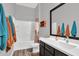 Modern bathroom vanity with dark wood cabinetry and a framed mirror at 21104 E Poco Calle --, Queen Creek, AZ 85142