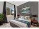 This bedroom boasts a textured rug, a king bed, and tasteful wall art for a serene retreat at 21104 E Poco Calle --, Queen Creek, AZ 85142