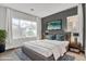 Main bedroom featuring a large window, gray accent wall, and a TV at 21104 E Poco Calle --, Queen Creek, AZ 85142