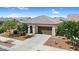 Single-story home with desert landscaping, a two-car garage, and a tile roof at 21104 E Poco Calle --, Queen Creek, AZ 85142