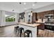 Kitchen with wood tile flooring, a large island with seating, and stainless steel appliances at 21104 E Poco Calle --, Queen Creek, AZ 85142