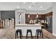Kitchen features dark cabinetry, granite counters, stainless appliances, and an island with seating at 21104 E Poco Calle --, Queen Creek, AZ 85142