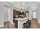 Kitchen with stainless appliances, dark wood cabinetry, and a granite countertop island with seating at 21104 E Poco Calle --, Queen Creek, AZ 85142