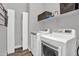 Bright laundry room featuring a front loading washer and dryer and storage at 21104 E Poco Calle --, Queen Creek, AZ 85142