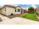 Exterior of home with lawn, gravel landscaping, and a covered patio at 22040 N 119Th Dr, Sun City, AZ 85373