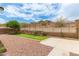 The backyard is landscaped with stone and artificial turf, and includes a low retaining wall at 22040 N 119Th Dr, Sun City, AZ 85373